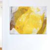 Abstract collage made of China paper in shades of yellow - partially waxed